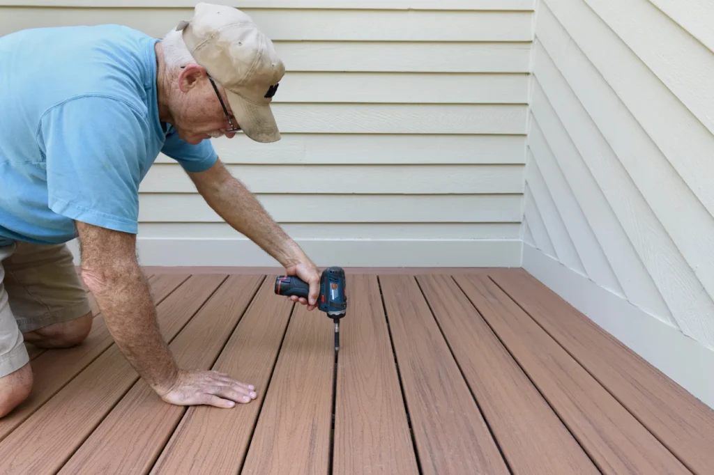 Skilled builder working on decking boards representing the about us team at Deck Builders Taupo.